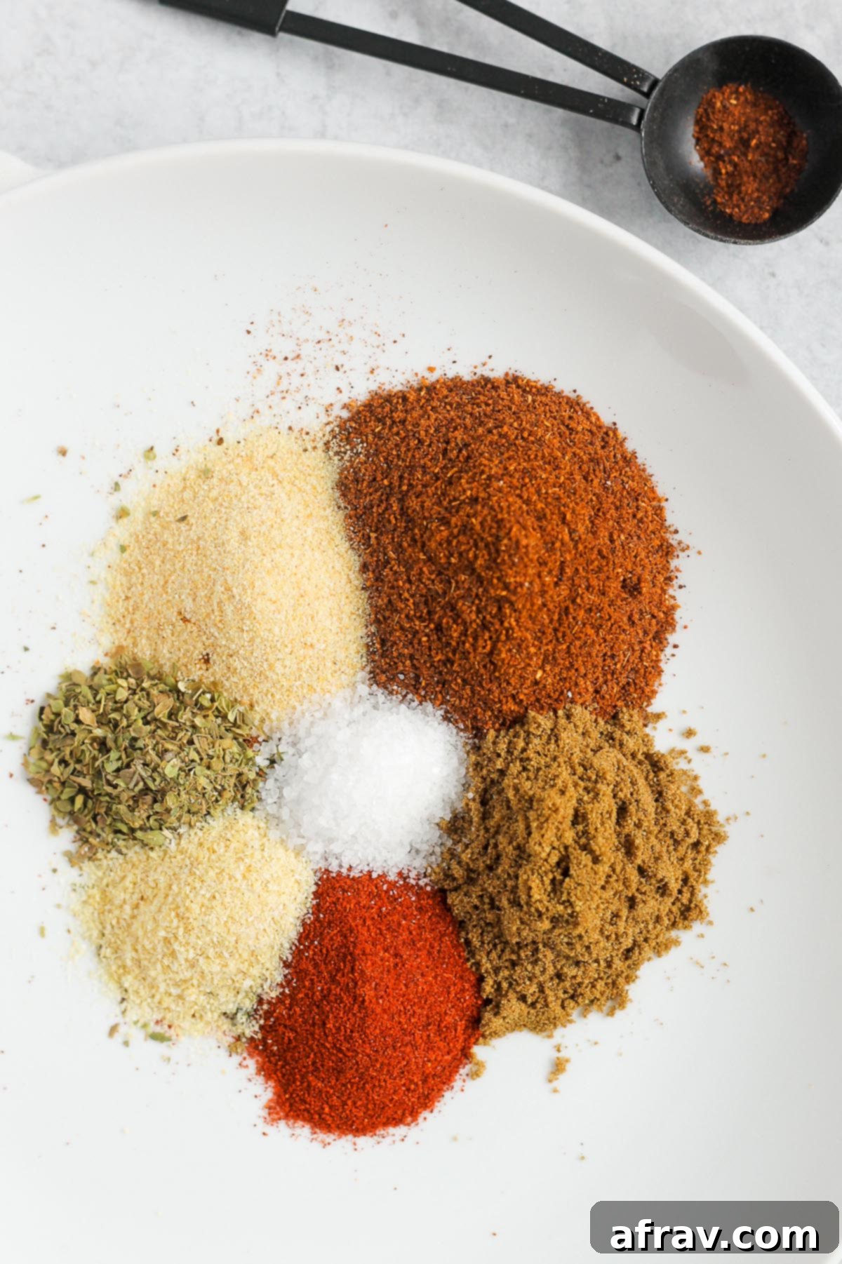 taco seasoning ingredients piled on a white plate
