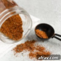side view of taco seasoning being poured from a mason jar