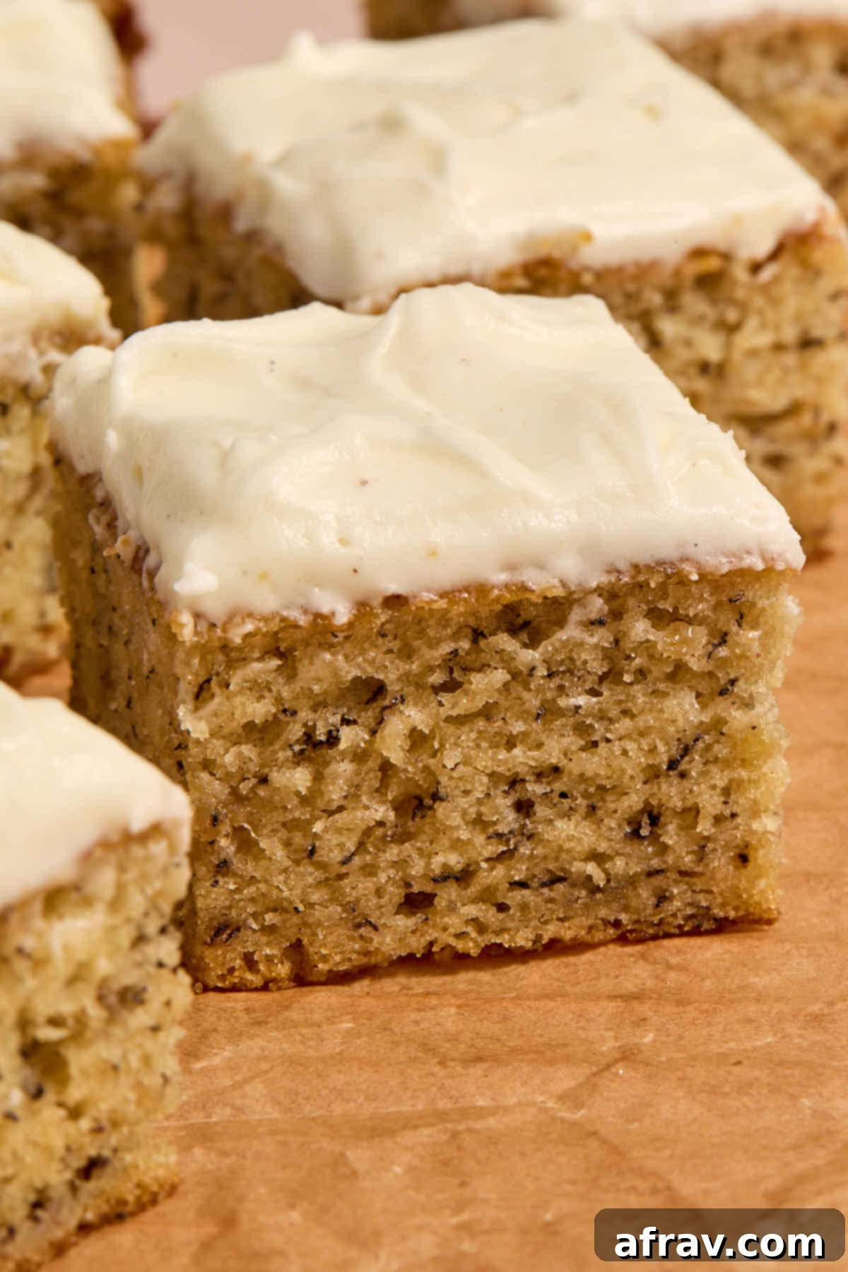 Double Sour Cream Banana Cake 2 Side view of a piece of frosted banana cake, showing its moist texture and generous frosting.