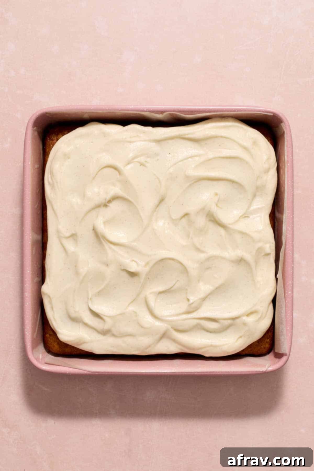 Double Sour Cream Banana Cake 12 Decadent sour cream frosting is expertly spread over the cooled banana cake still in its pan, creating a smooth and inviting finish.