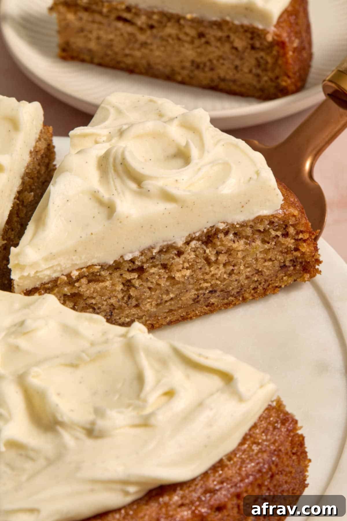 Angled view of a slice of cake on a white platter.