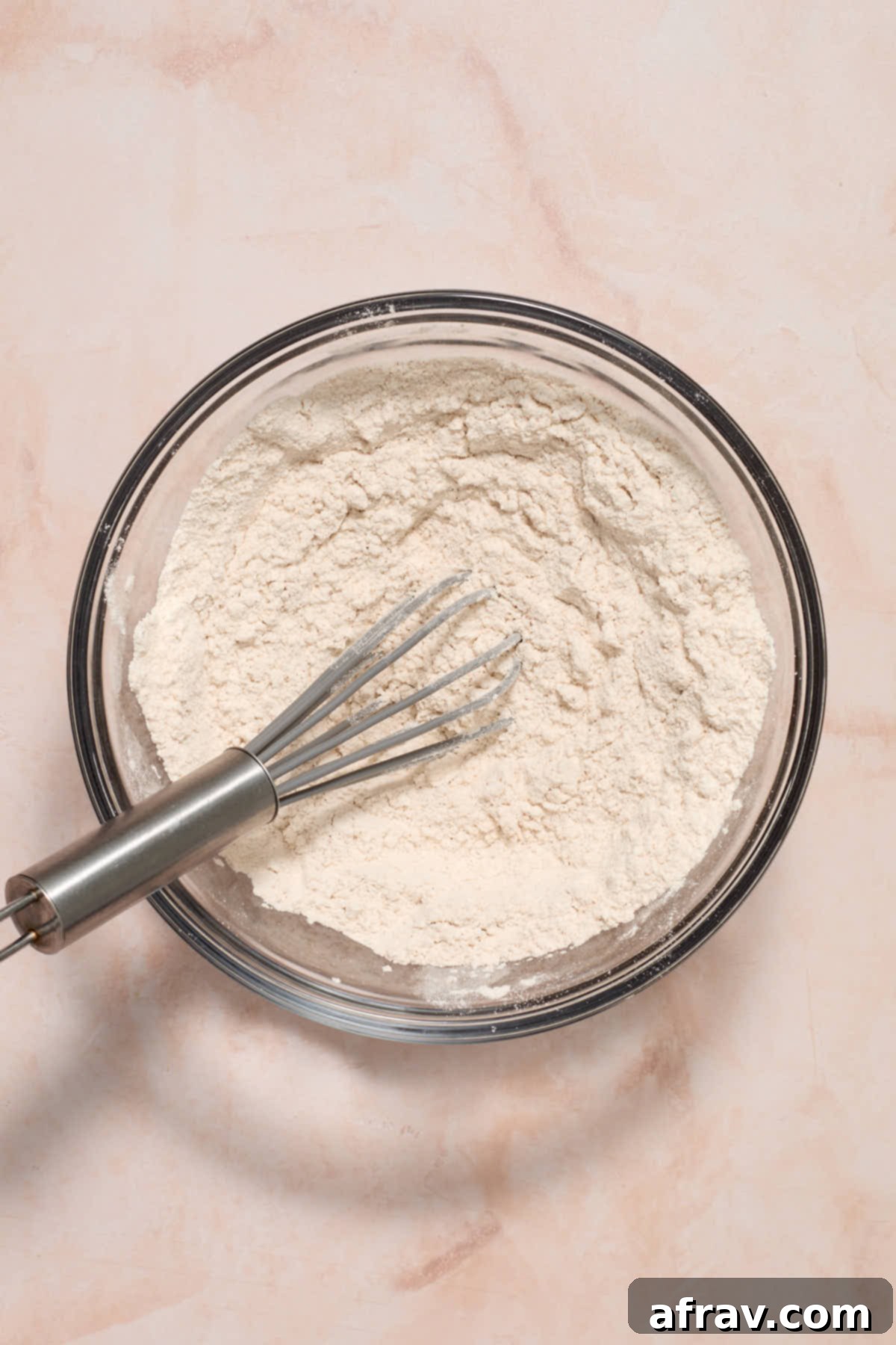 Dry ingredients combined in a glass bowl.