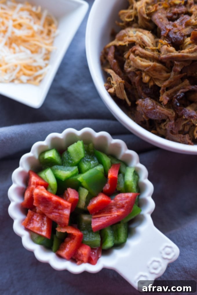 Maple Pulled Pork Stuffed Spaghetti Squash with vibrant peppers.