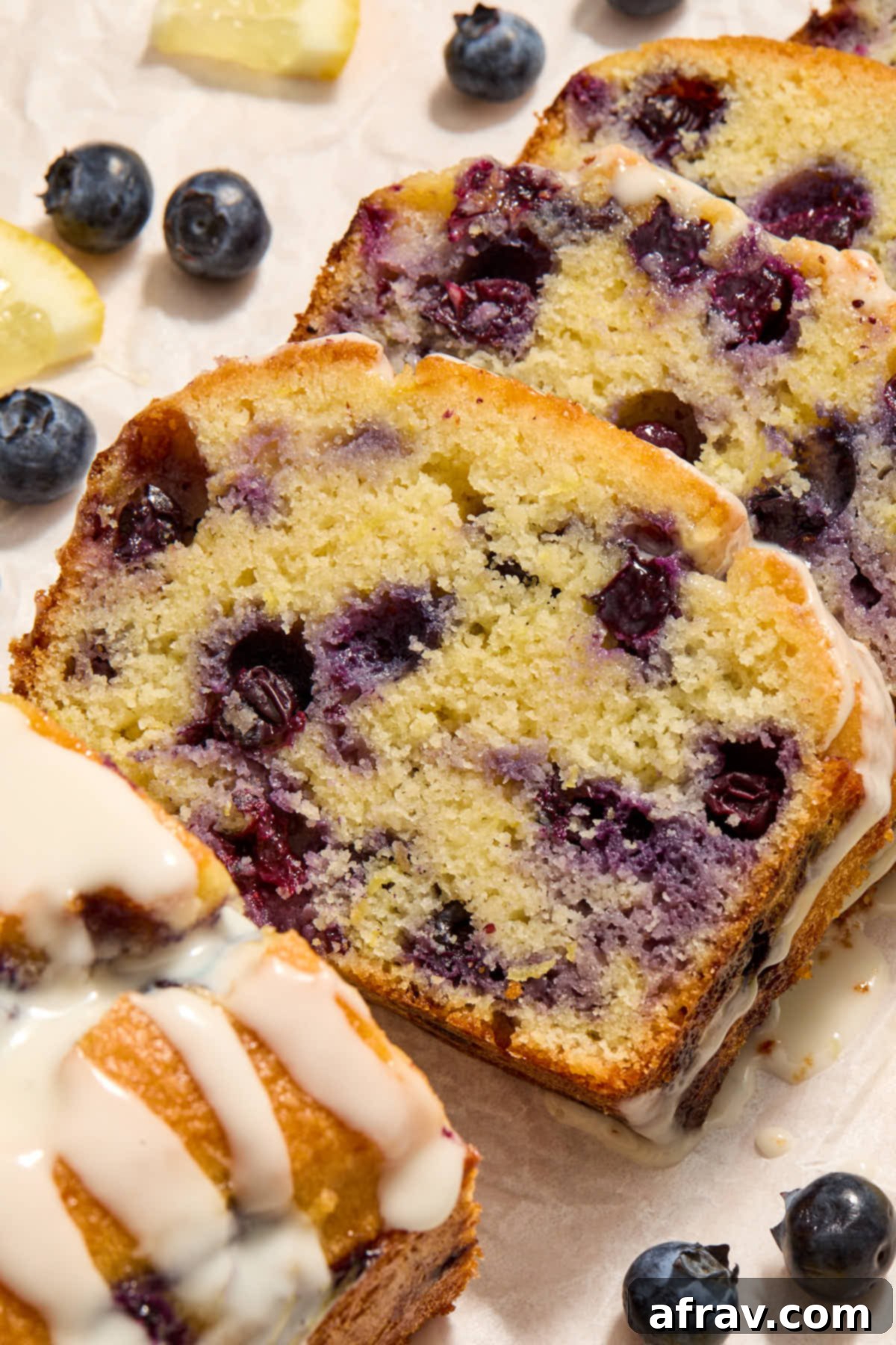 Close up view of a slice of lemon blueberry bread.