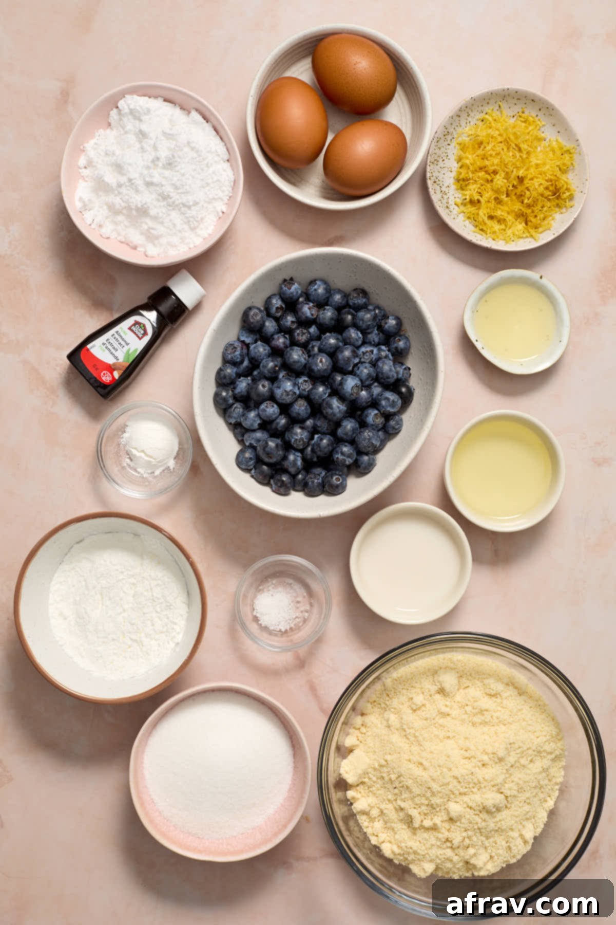 Ingredients to make lemon blueberry bread with almond flour arranged in individual bowls.