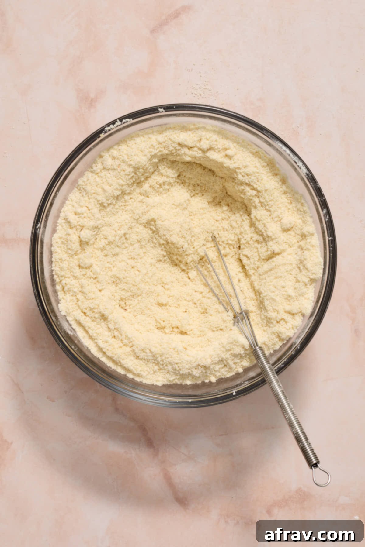 Dry ingredients whisked together in a glass bowl.
