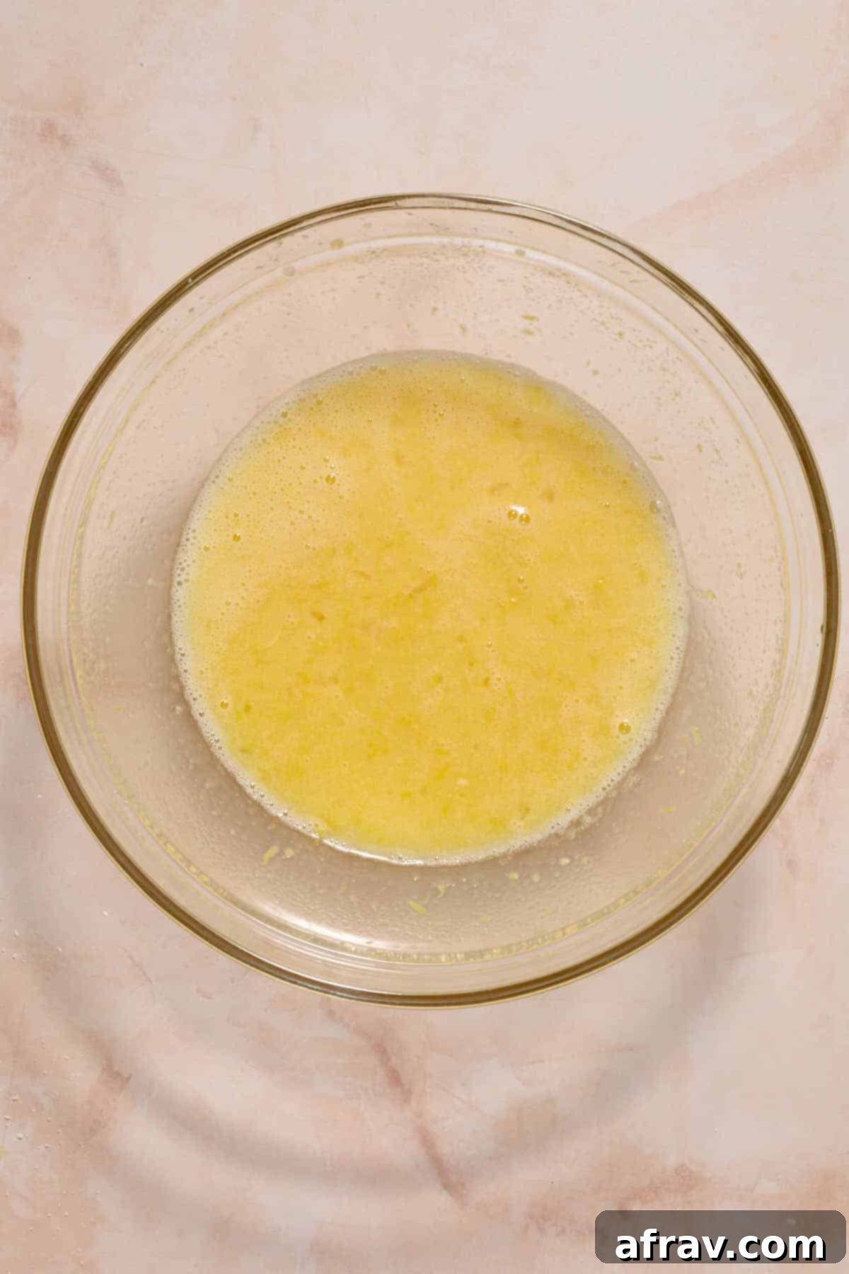Wet ingredients combined in a large glass bowl.