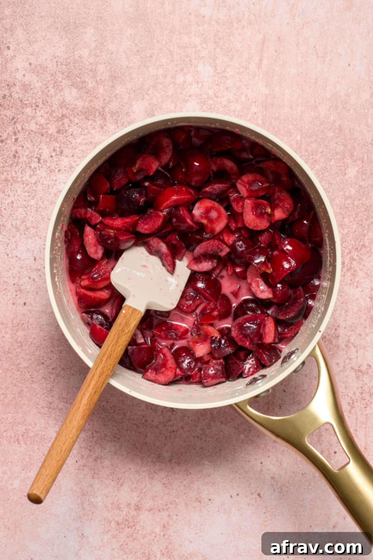 Cherry filling ingredients stirred together in a small saucepan before cooking.