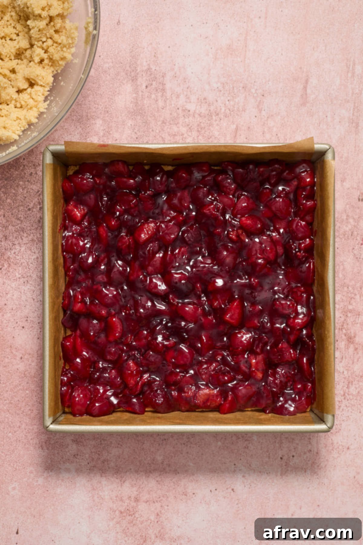 Thickened cherry filling spread out evenly on the cooled pie crust.