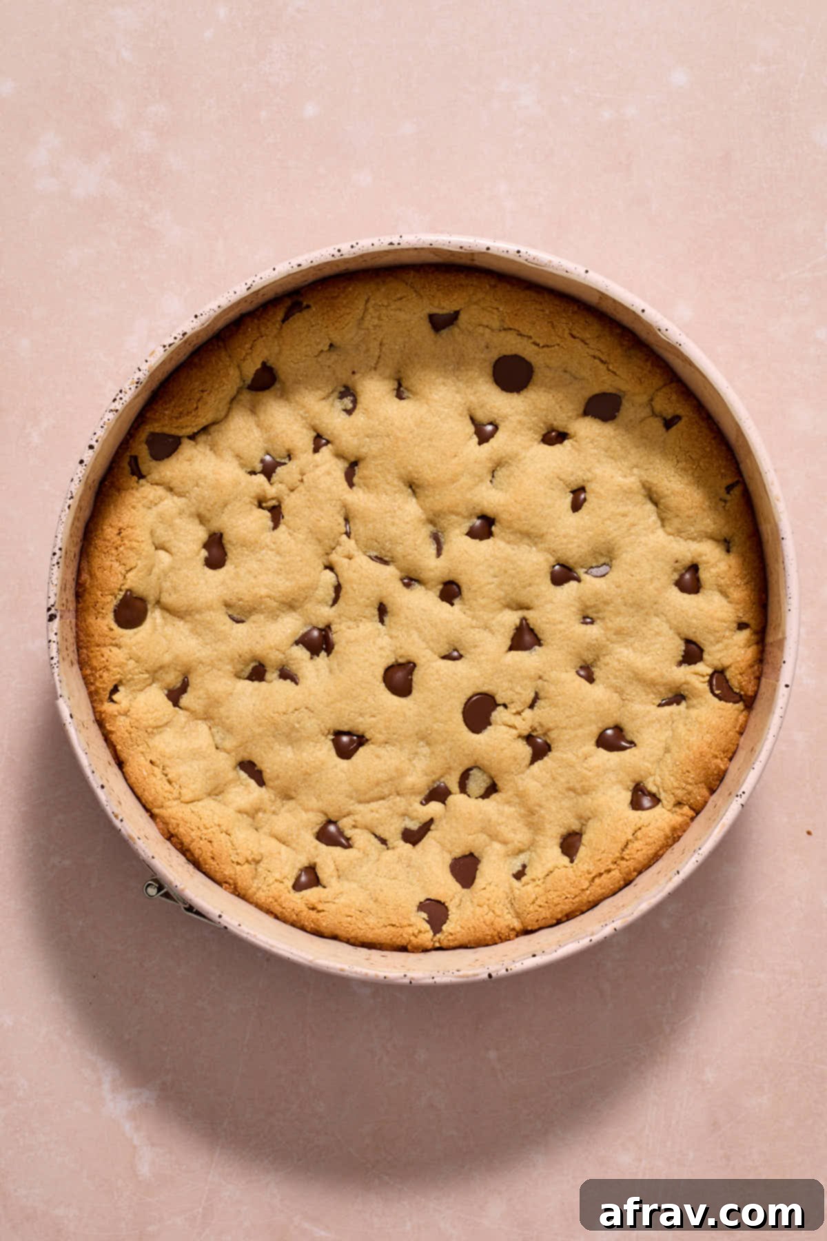 Cookie cake baked and cooling in pan.