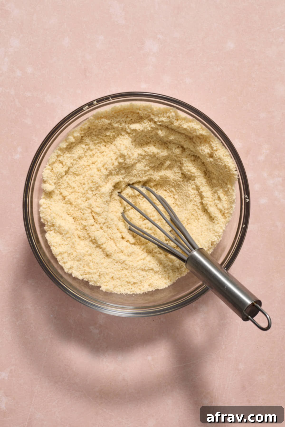 Dry ingredients whisked together in a glass bowl.