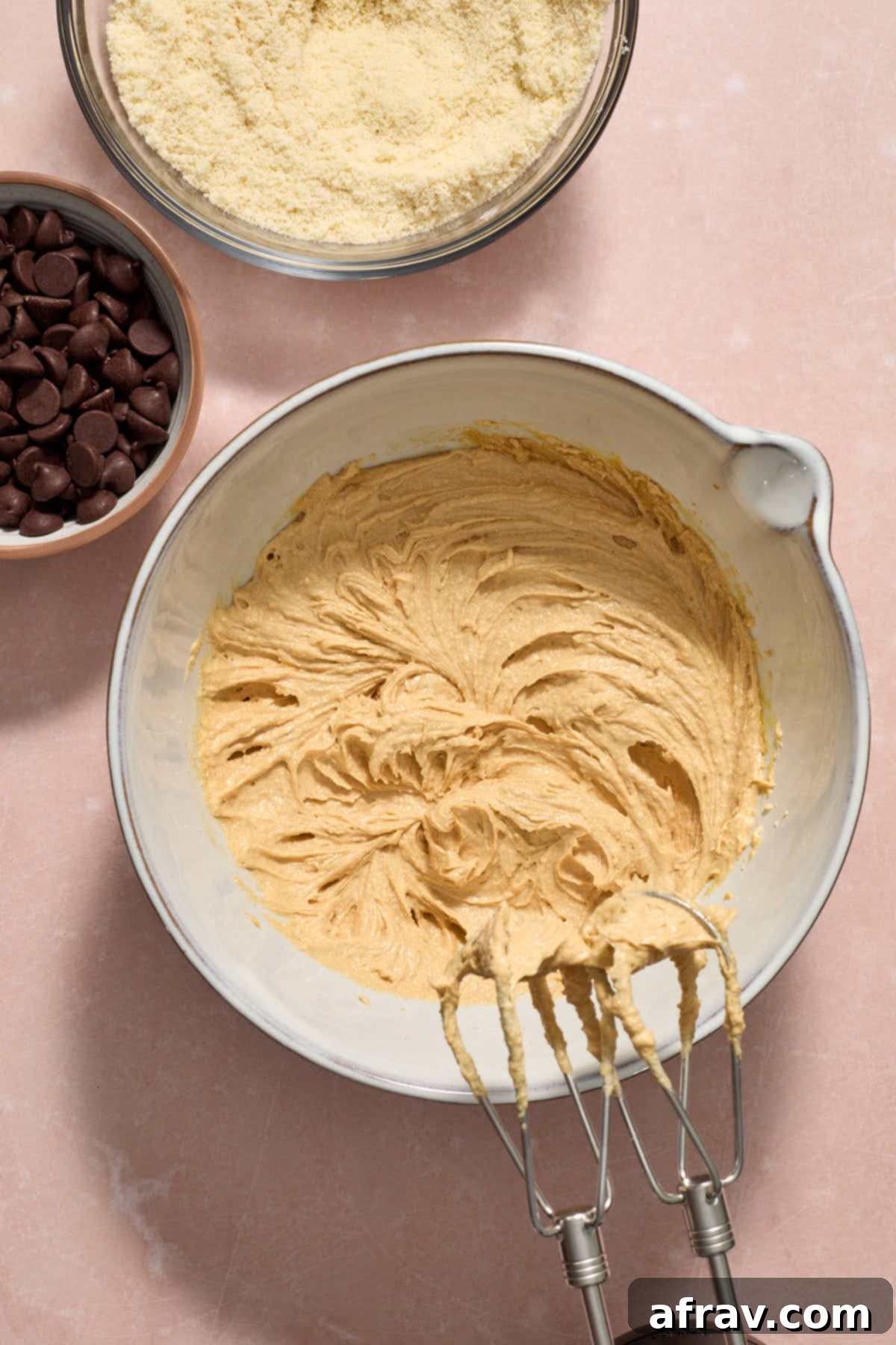 All the wet ingredients mixed together in a bowl with the dry mixture and chocolate chips on the side.