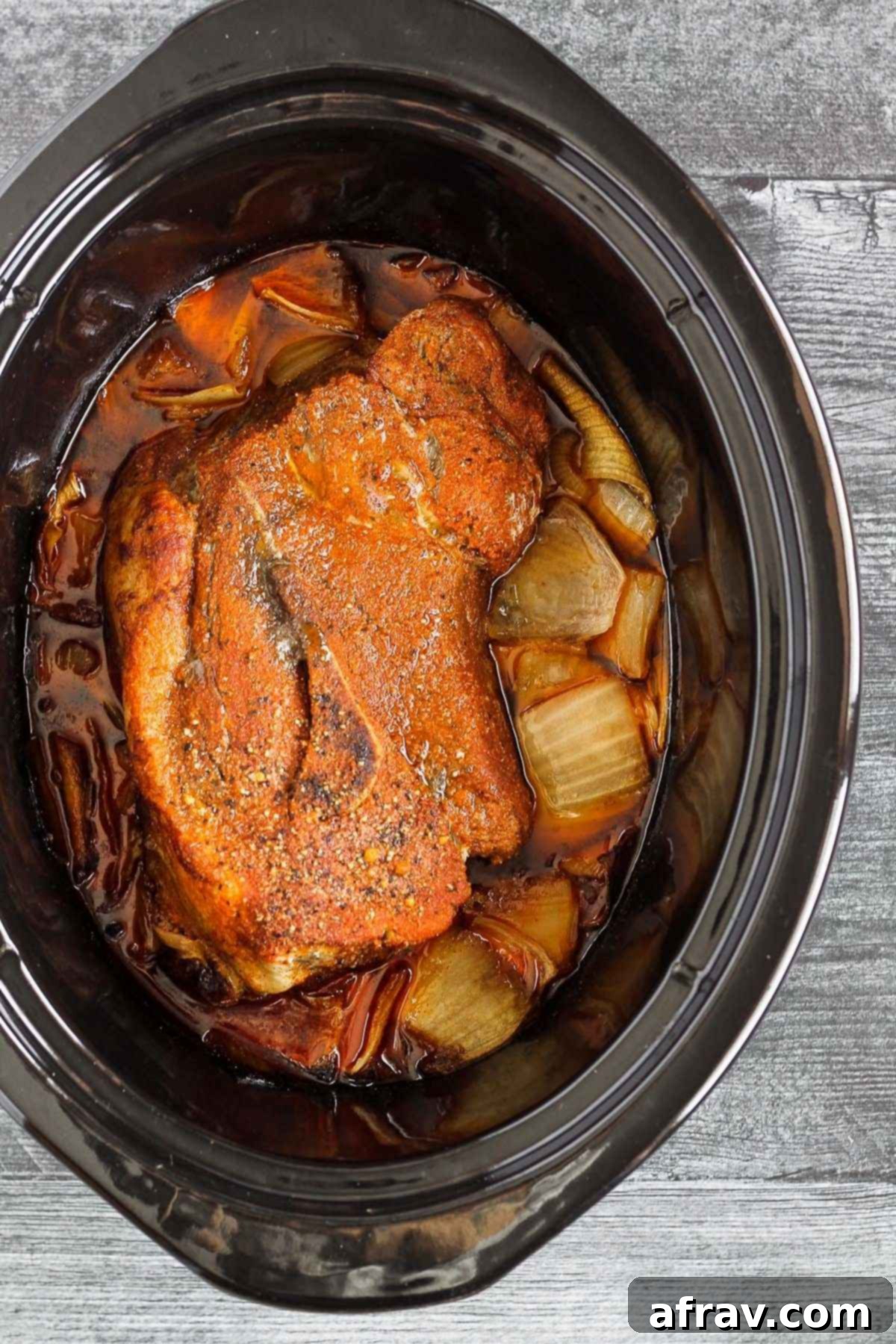 Cook pork roast with onions in a slow cooker.