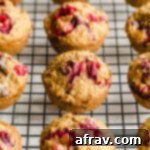 Cranberry oatmeal muffins arranged on a wire rack to cool.