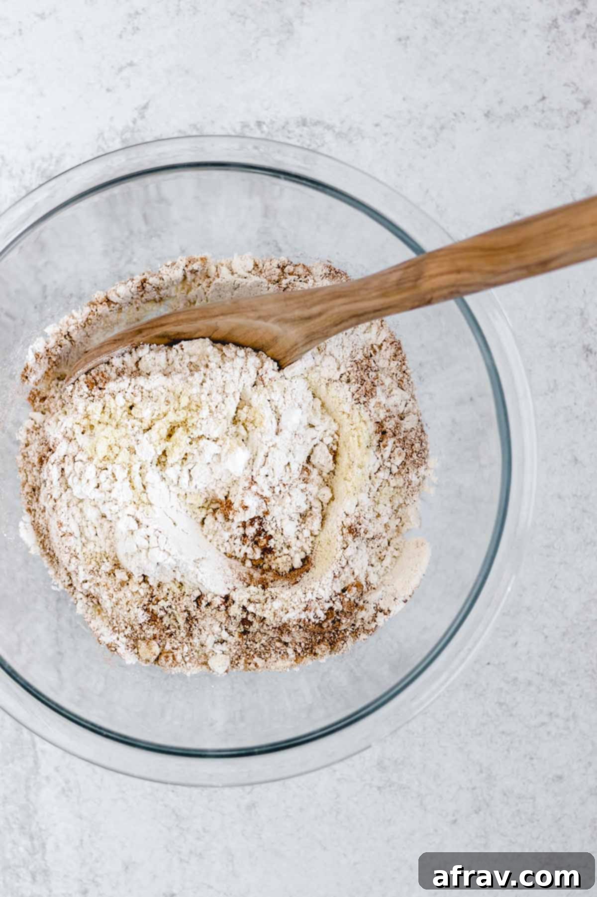 Dry ingredients mixed together in a large white bowl, ready for the wet ingredients.