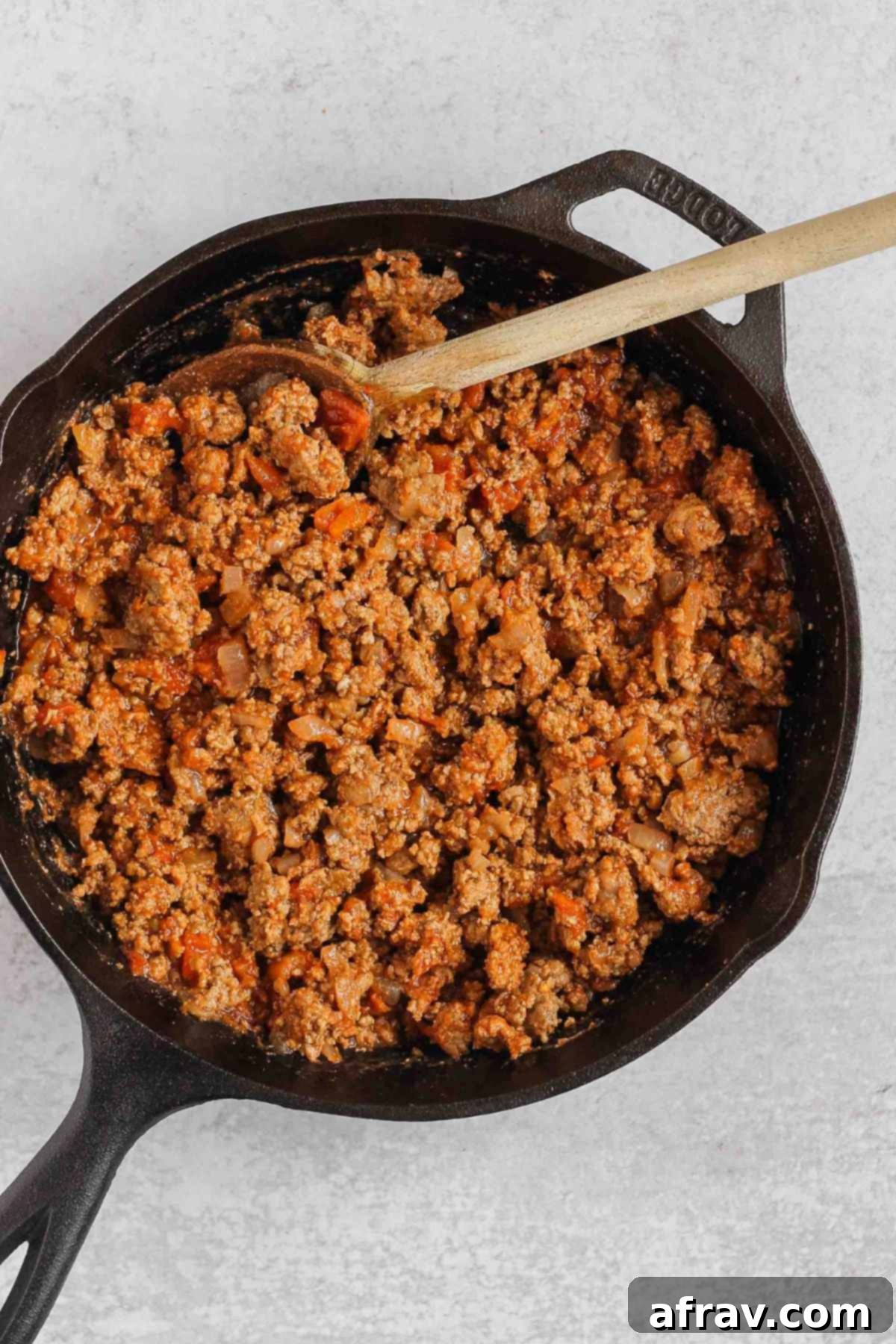 Chili filling for stuffed sweet potatoes in a cast iron skillet.