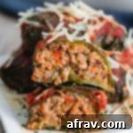 Stuffed Collard Greens cut in half and arranged on top of each other on a small plate.