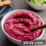 Roasted Beet and White Bean Hummus in a small, white bowl.