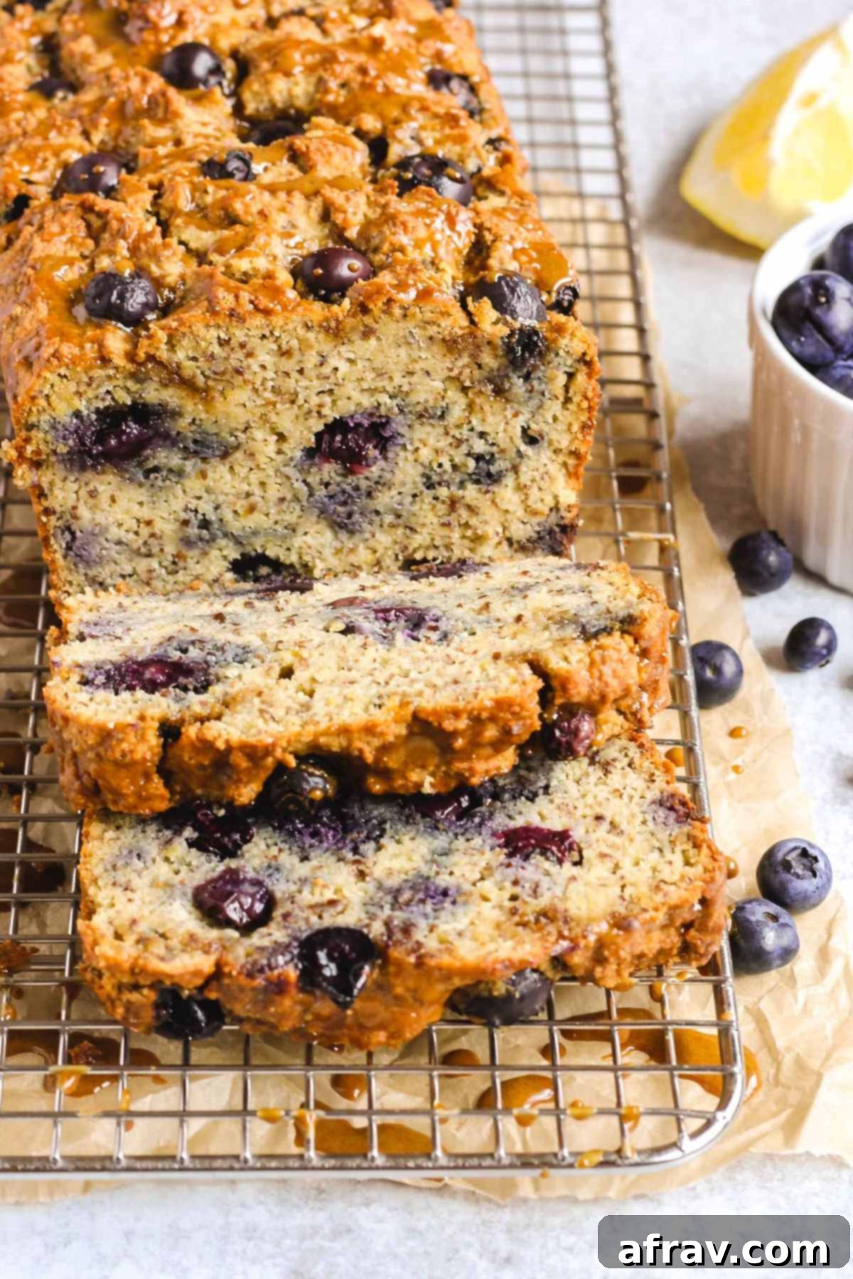 Zesty Lemon Blueberry Almond Loaf 2 Sliced loaf of almond flour blueberry lemon bread, showing a tender crumb and juicy blueberries.