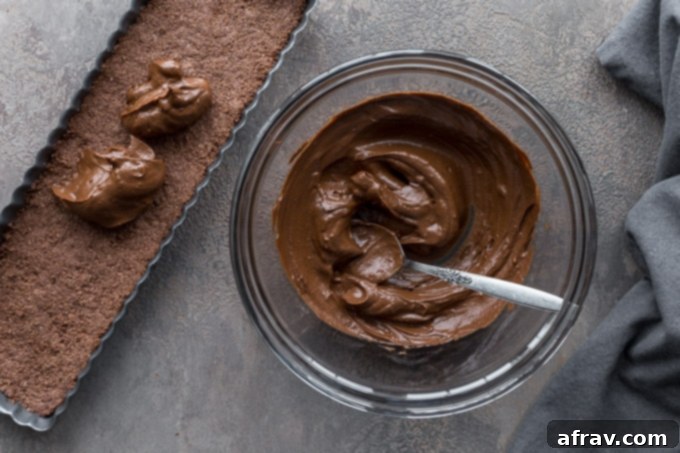 Chocolate filling in bowl with a spoon.