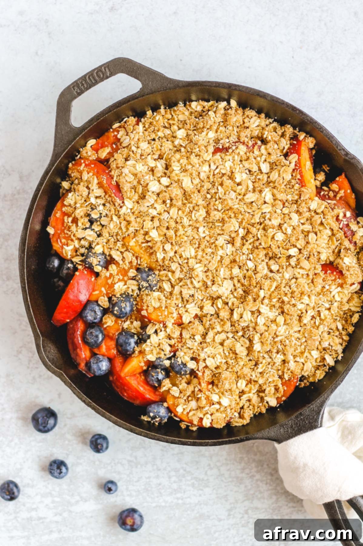 peach and blueberry crisp in cast iron skillet prior to baking