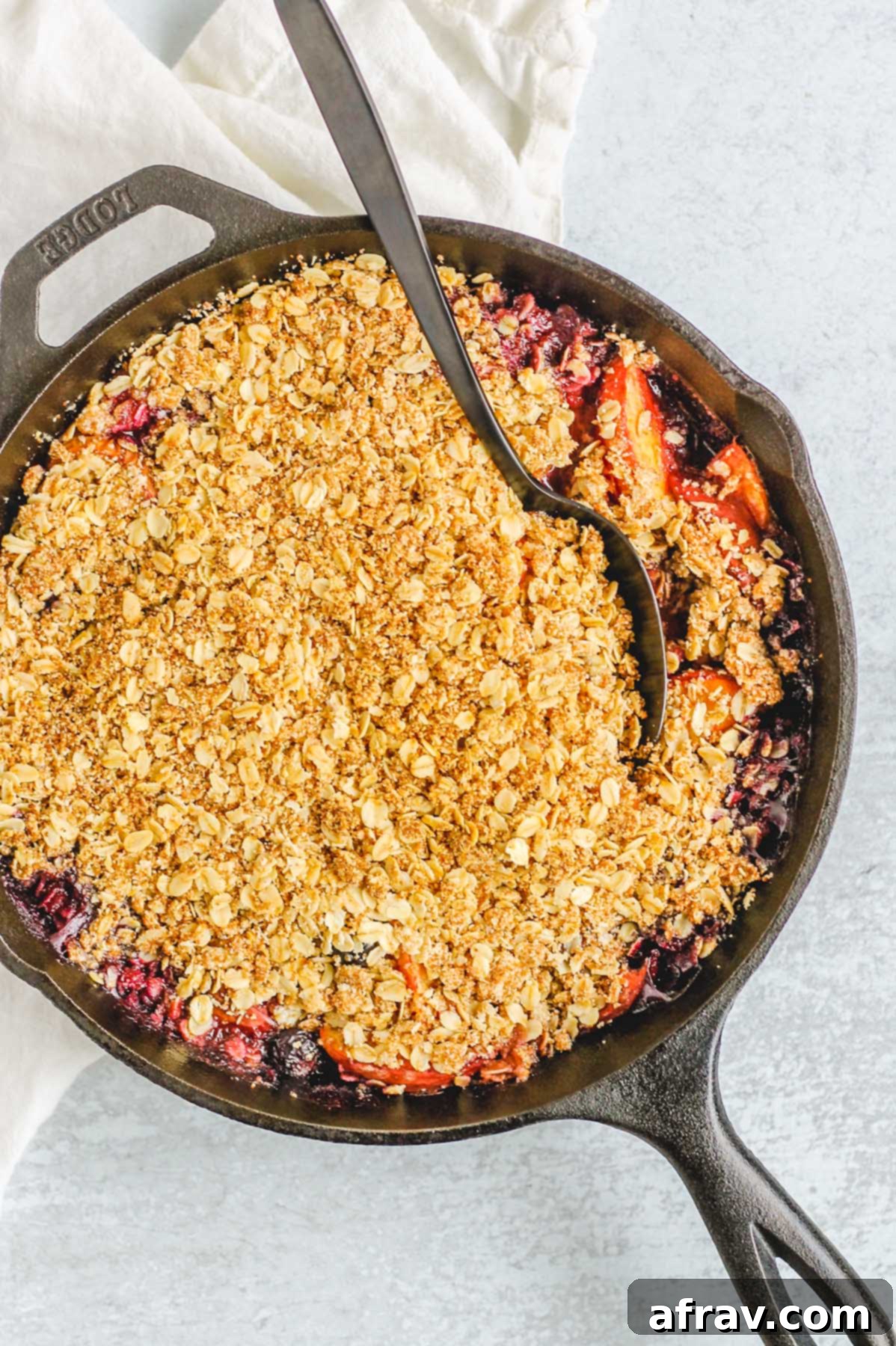 baked peach crisp in black cast iron skillet