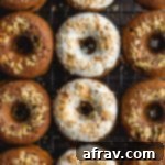 Carrot Cake Donuts arranged closely together on a wire rack.