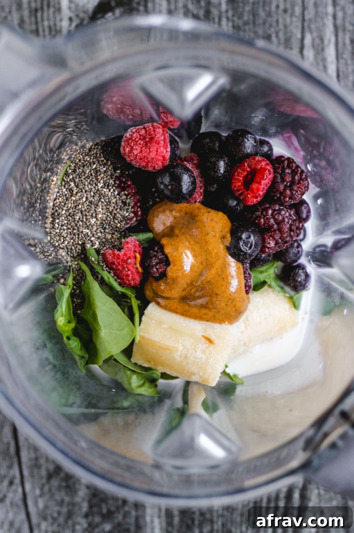 Plant-Based Berry Spinach Smoothie 4 chia seeds, spinach, banana, almond butter, frozen mixed berries, and almond milk in blender before being blended