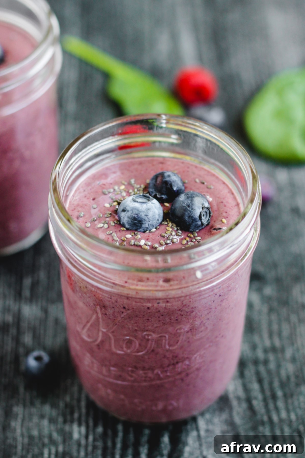 Plant-Based Berry Spinach Smoothie 5 side angle view of the berry spinach smoothie in a glass mason jar