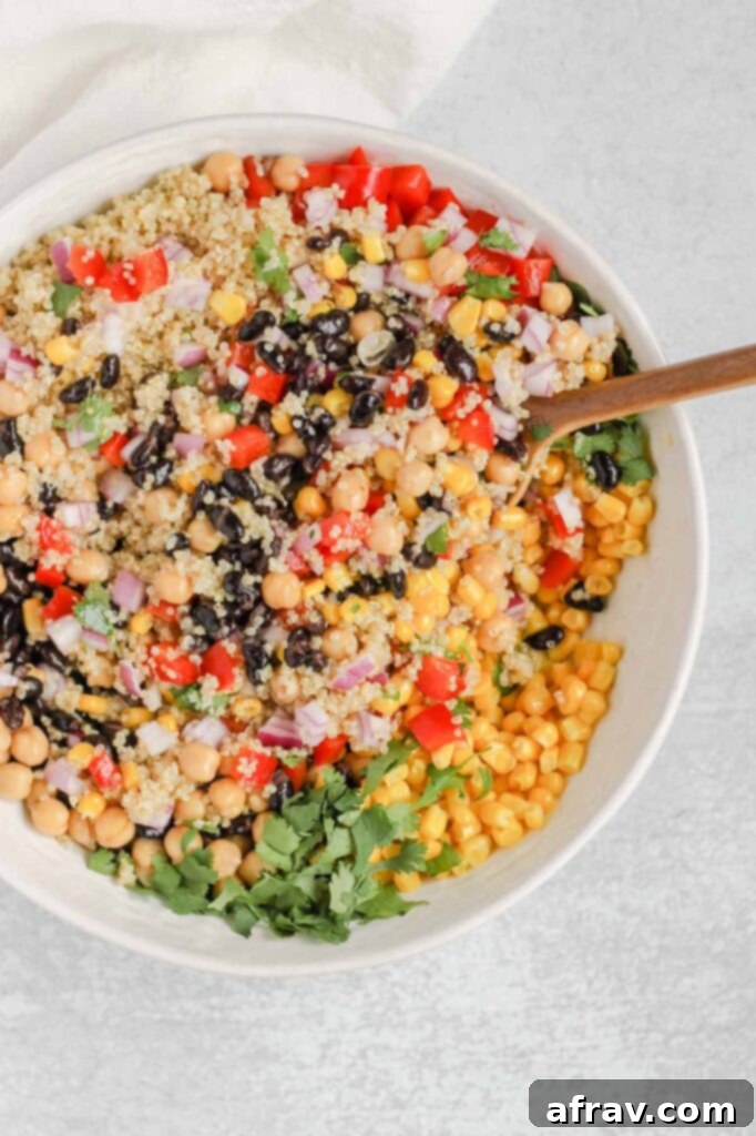 The southwest quinoa salad tossed with the lime vinaigrette, showing the uniform coating and rich colors.