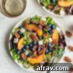 Summer Peach Salad with Blueberries served on white plates.
