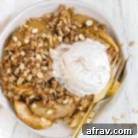 Wholesome Gluten-Free Apple Crisp Made Easy 8 Individual serving of apple crisp on a white plate with a gold fork with a scoop of ice cream on top.