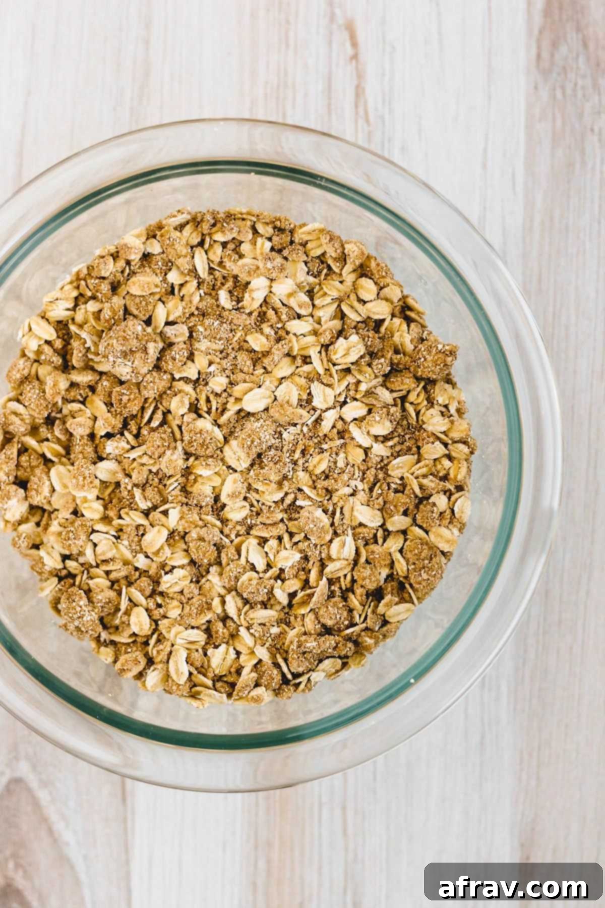 Wholesome Gluten-Free Apple Crisp Made Easy 4 Close-up of the oat crumble topping for apple crisp in a small glass mixing bowl, showing its crumbly texture.