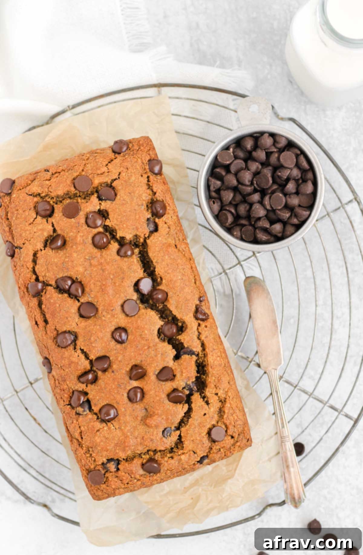Irresistible Gluten Free Chocolate Chip Pumpkin Bread 12 Gluten-free pumpkin chocolate chip loaf cooling on a round wire cooling rack, viewed from above.