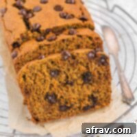Irresistible Gluten Free Chocolate Chip Pumpkin Bread 13 Sliced pumpkin chocolate chip bread on a white plate, ready to be served.