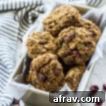 Up-close view of Avocado Pumpkin Oatmeal Breakfast Cookies arranged in a loaf pan on a wooden surface.