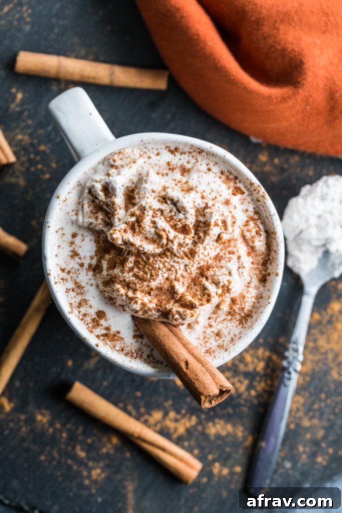Homemade Pumpkin Spice Latte with Coconut Whip, a healthier holiday drink.