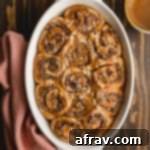 Quick Chocolate Hazelnut Swirls 2 Overhead view of chocolate hazelnut rolls in a white dish on a brown wooden surface.
