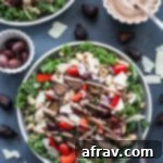 Fig Tahini Dressed Tuscan Farro Salad 2 Up-close view of a single plate of Tuscan Farro Salad with Fig Tahini Dressing, ready to be served, showcasing its fresh ingredients and creamy dressing.