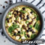 Vibrant Mediterranean Quiche with Golden Almond Crust 2 Overhead view of Mediterranean Quiche in a pie plate, with slices served up on surrounding plates.