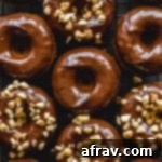 Protein donuts topped with chocolate peanut butter glaze and chopped peanuts.