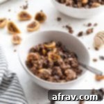 Chocolate Fig Grain-Free Granola in white bowls on a white surface.