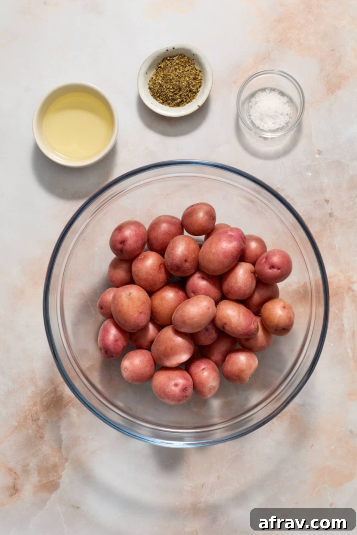 Ingredients to make air fryer baby potatoes arranged in individual bowls.