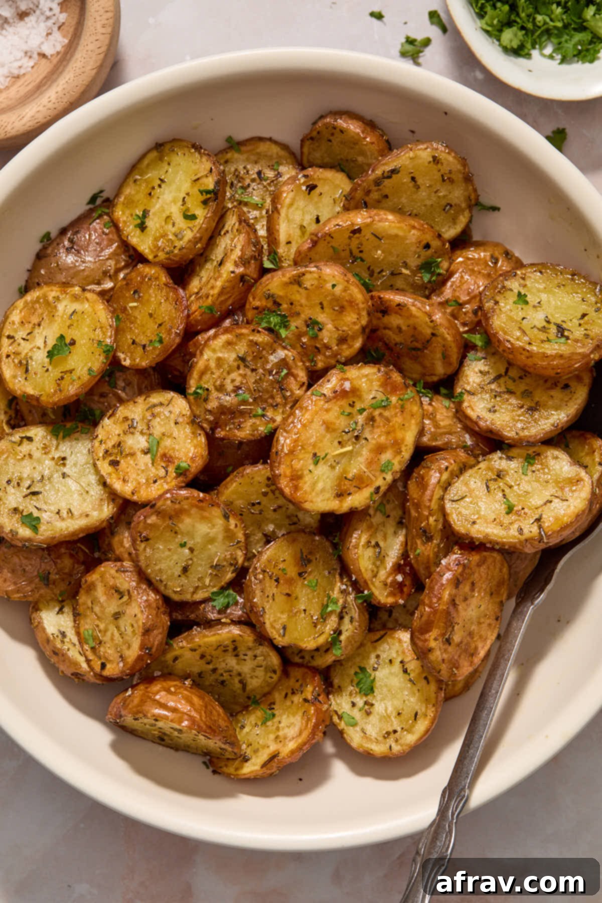 Potatoes served in a bowl with a spoon.