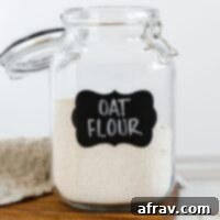 Oat flour in a labeled glass canister.