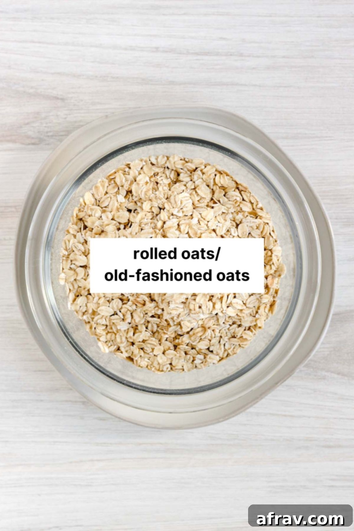 Rolled oats in a glass bowl with text overlay "rolled oats/old-fashioned oats."