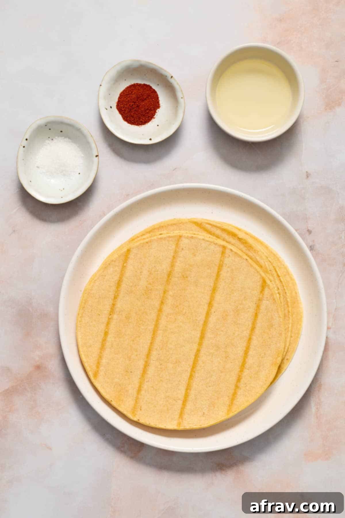 Ingredients to make air fryer tortilla chips arranged individually on a surface.