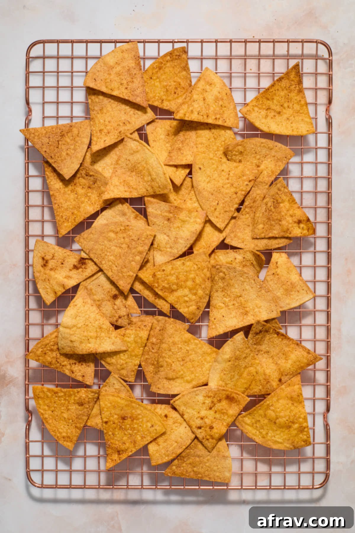Air fryer tortilla chips cooling on a wire rack.