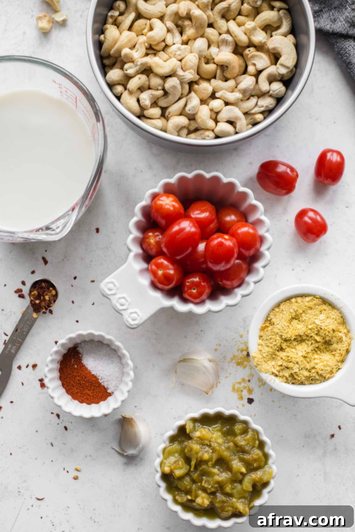 Ingredients arranged on a marbled surface to make dairy-free queso.