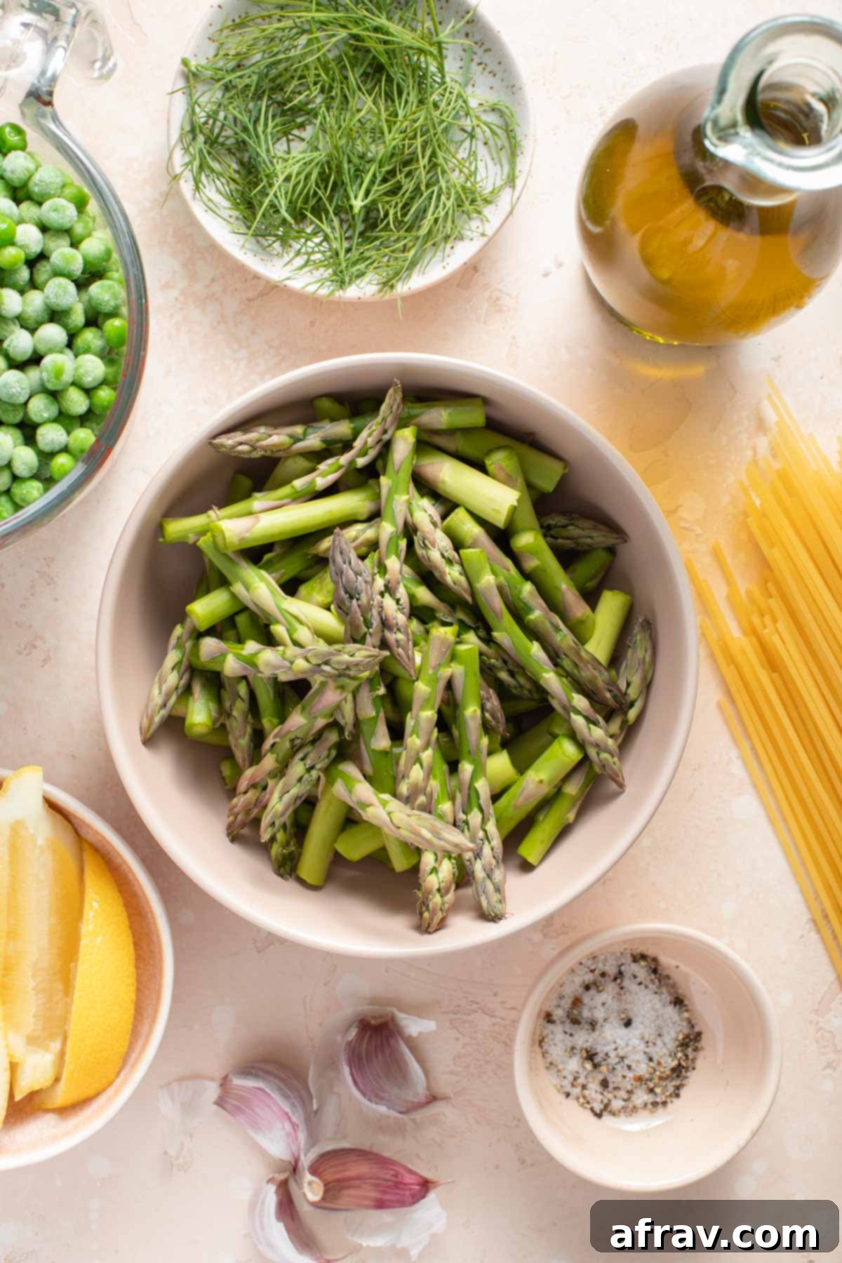 Ingredients to make lemon garlic pasta arranged individually.